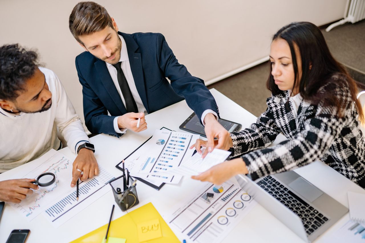 Services Business professionals engaging in a collaborative meeting with charts and documents.